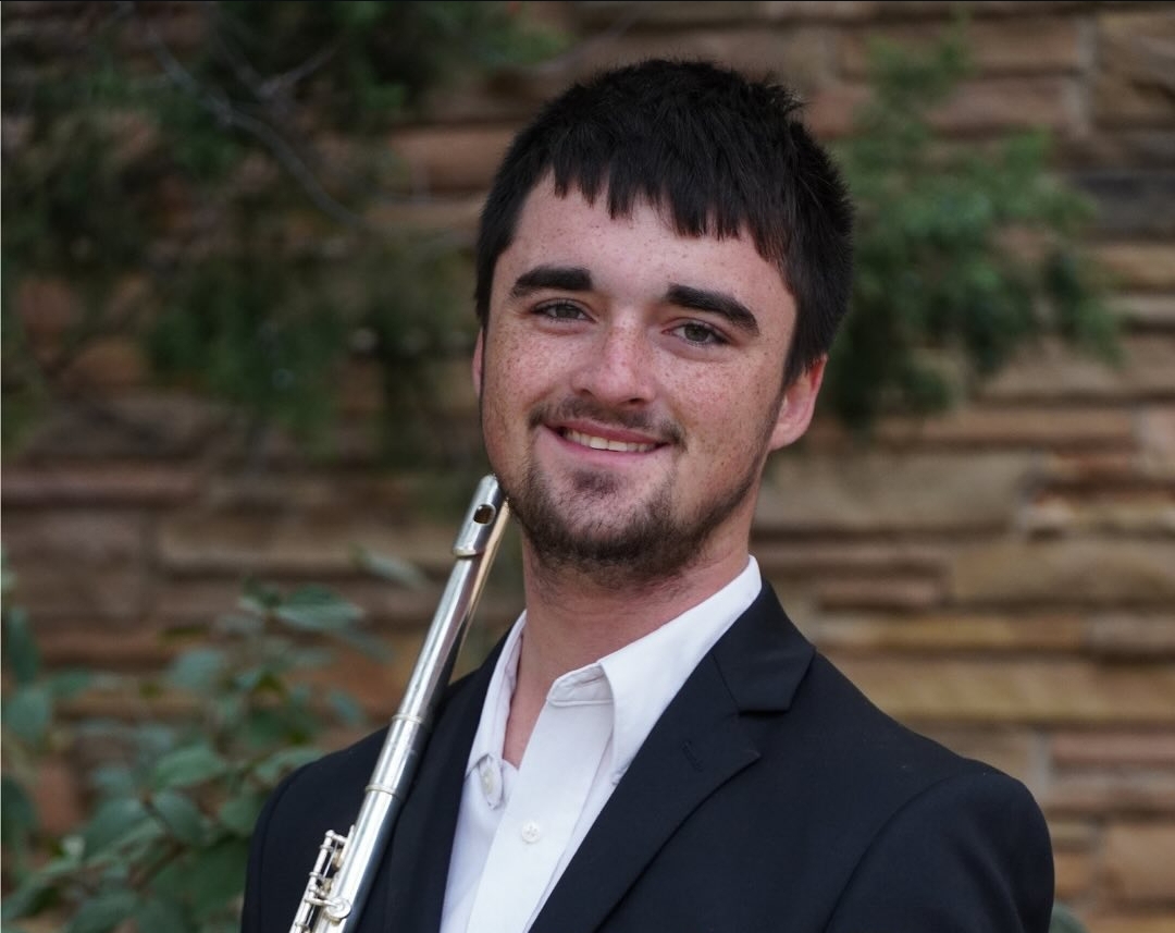 Nathan Lynn holding his flute